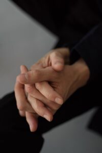 Close-up of clasped hands conveying a sense of support and tenderness.